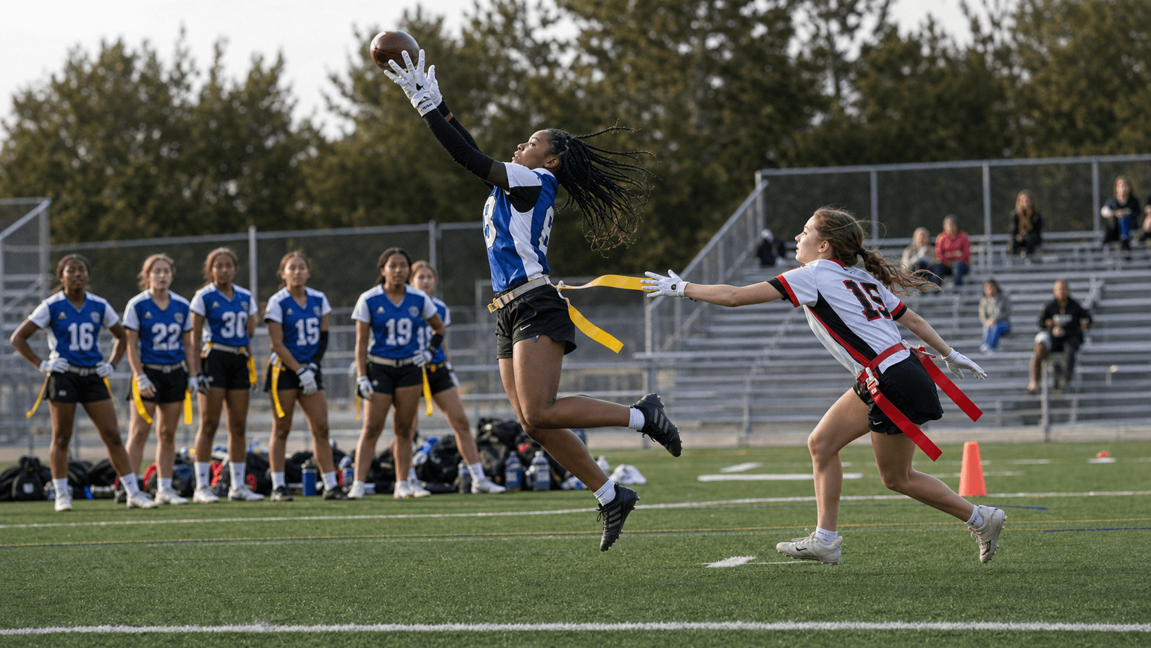 Youth flag football players jumping for a catch