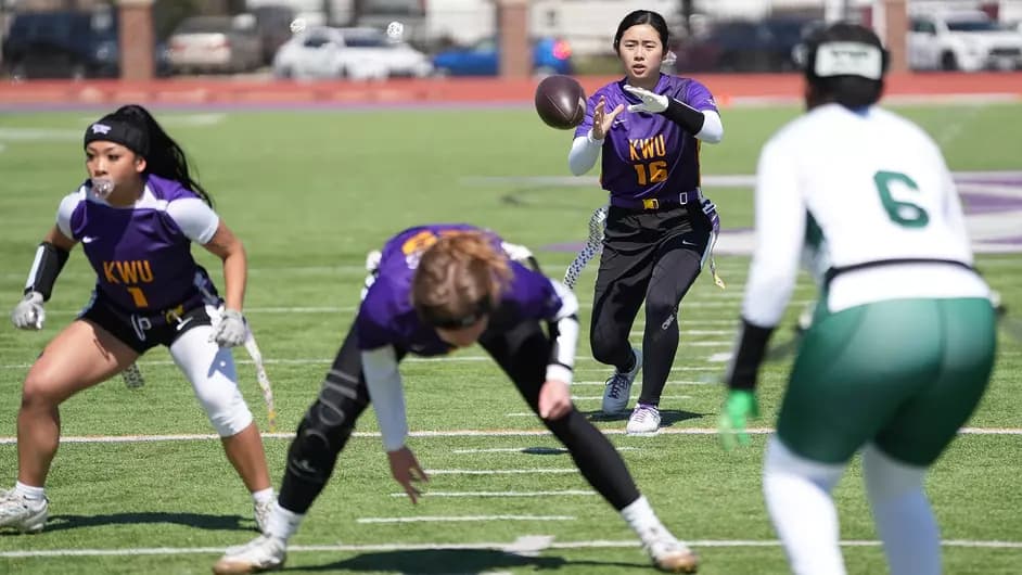 Kansas Wesleyan women’s flag football players set up for a play on the field
